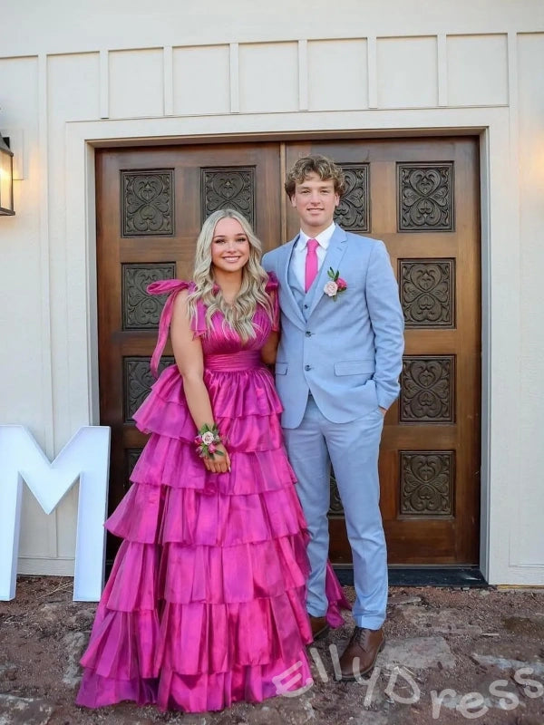 Pink Iridescent Wide Strap Bow Tie Deep V-Neck Tiered Cake Ball Gown Prom Dress with Metallic Jacquard Fabric Wide Waistband Eight-Layer Ruffles and Open Back